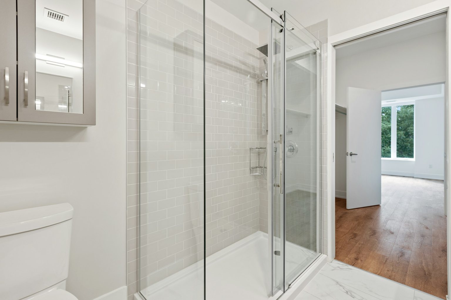 Bathroom with a glass-enclosed walk-in shower, subway tile and tiled floor